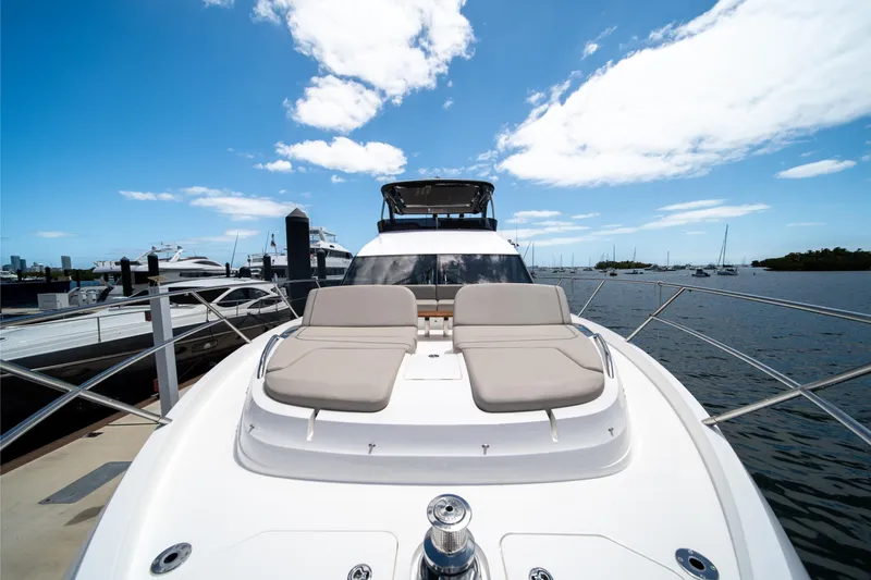 Slide: The Image of 2025 Princess F65 yacht with sun loungers, docked under a clear blue sky. - 34