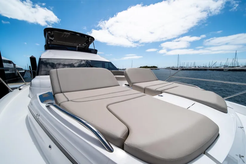 Slide: The Image of Luxurious 2025 Princess F65 yacht with sun loungers on deck, docked at marina. - 35