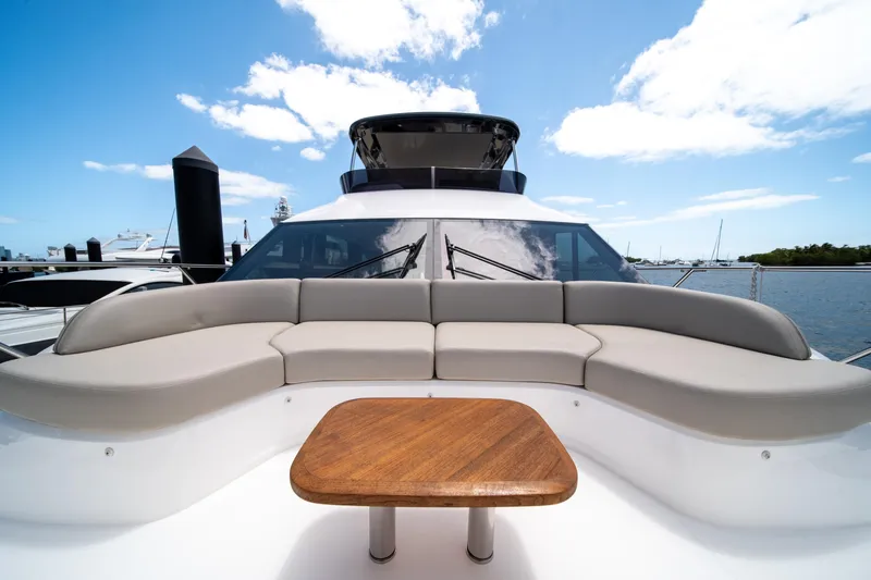 Slide: The Image of Luxurious 2025 Princess F65 yacht with elegant seating and wooden table on deck. - 36