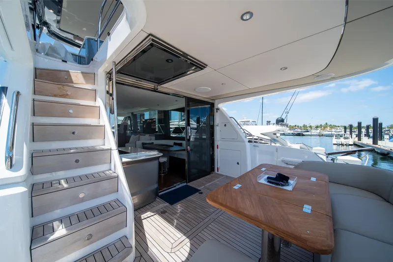 Slide: The Image of Luxurious 2025 Princess F65 yacht interior with wooden stairs and elegant seating area. - 7