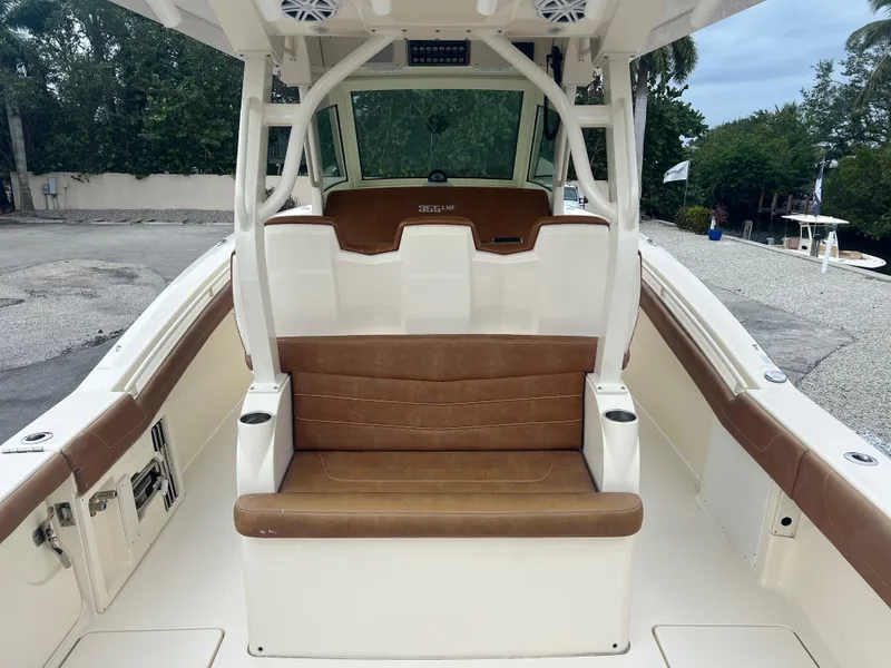 Slide: The Image of 2019 Scout 355 LXF boat interior with brown seating and white trim. - 10