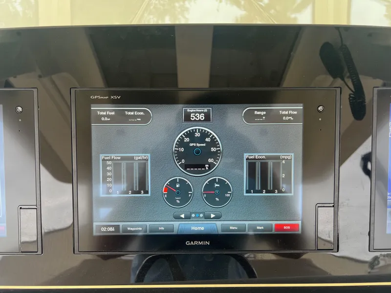 Slide: The Image of Garmin display on 2019 Scout 355 LXF boat dashboard showing fuel and speed metrics. - 14