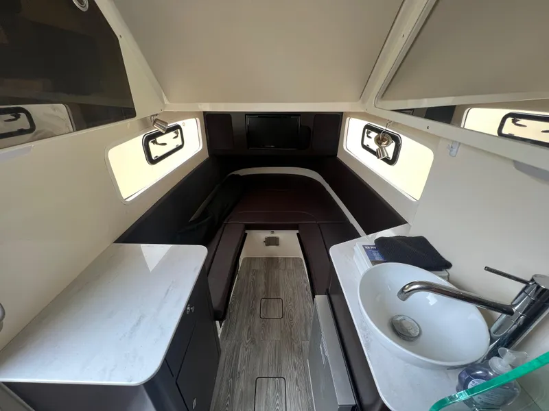 Slide: The Image of 2019 Scout 355 LXF cabin interior with bed, sink, and windows. - 16
