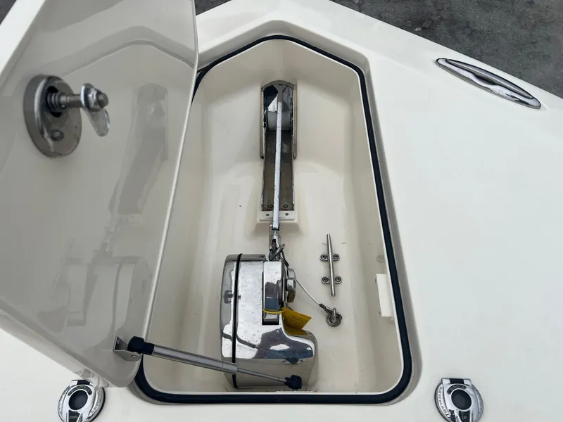 Slide: The Image of Anchor compartment of 2019 Scout 355 LXF boat with open hatch. - 24