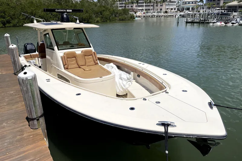 Slide: The Image of 2019 Scout 355 LXF boat docked, featuring luxurious design. - 27