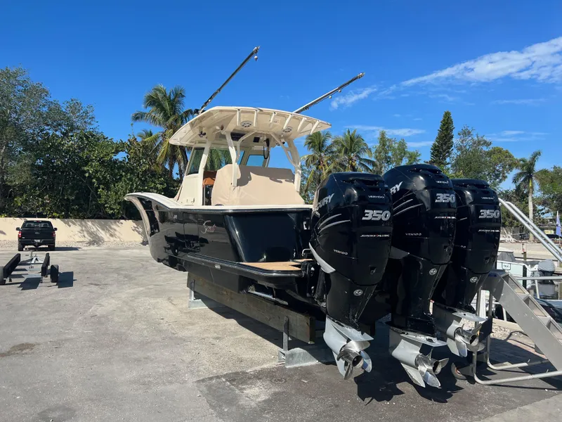Slide: The Image of 2019 Scout 355 LXF boat with triple 350 engines on a sunny day. - 6