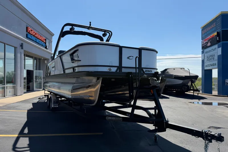 Slide: The Image of 2026 Crest Caribbean 250 SLS pontoon boat on trailer at dealership. - 10