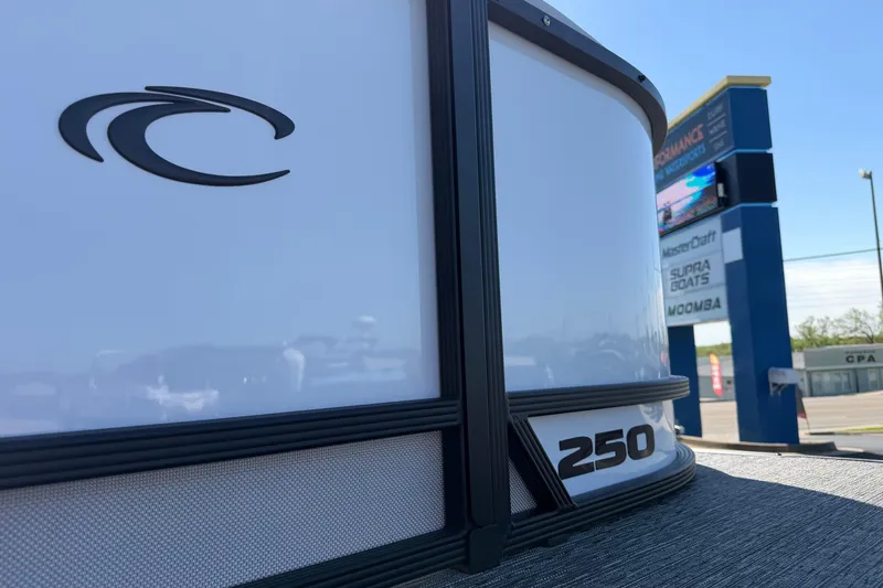 Slide: The Image of 2026 Crest Caribbean 250 SLS boat close-up with dealership sign in background. - 11