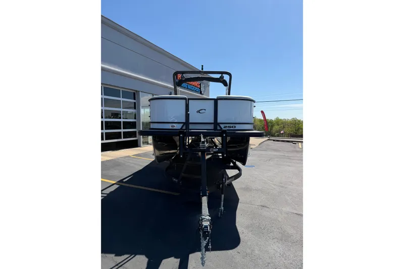 Slide: The Image of 2026 Crest Caribbean 250 SLS boat on trailer, parked outside dealership. - 15