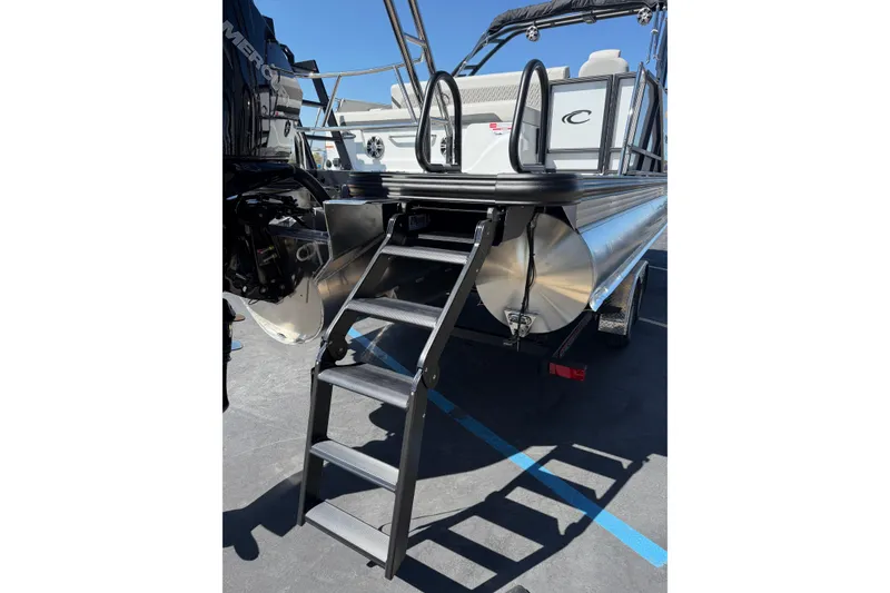 Slide: The Image of 2026 Crest Caribbean 250 SLS pontoon boat with rear ladder and motor. - 18
