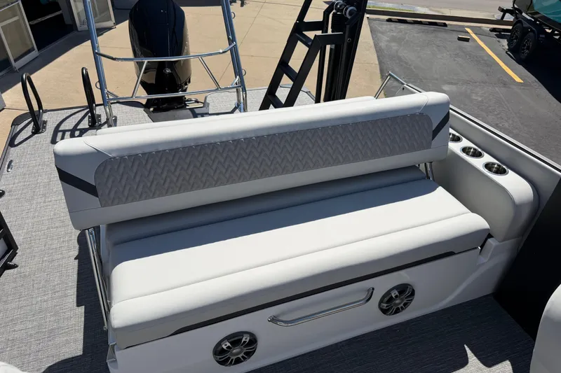 Slide: The Image of 2026 Crest Caribbean 250 SLS boat interior with cushioned seating and cup holders. - 20