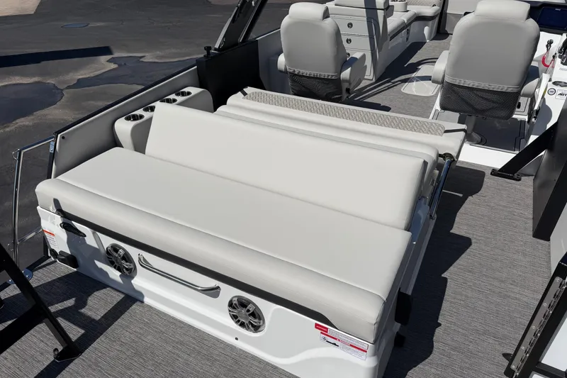 Slide: The Image of 2026 Crest Caribbean 250 SLS boat interior with gray seating and cup holders. - 22