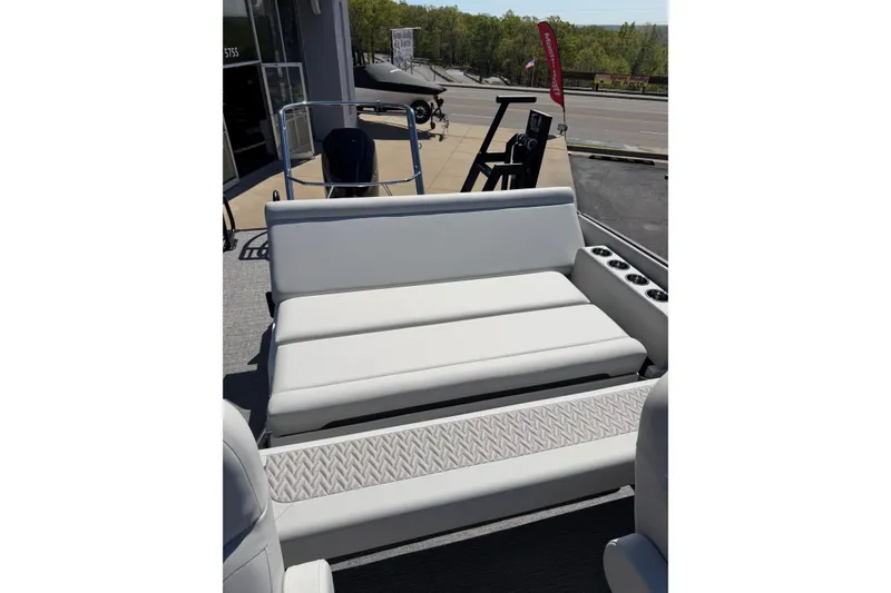 Slide: The Image of 2026 Crest Caribbean 250 SLS boat interior with white seating and cup holders. - 23