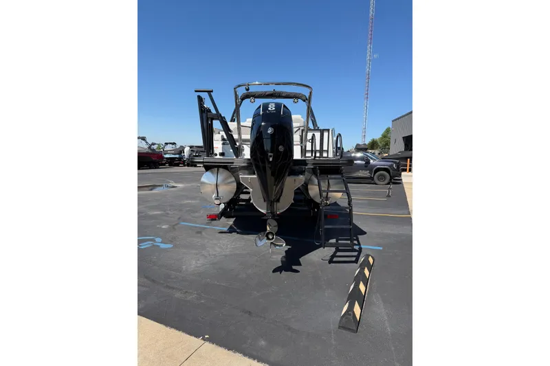 Slide: The Image of 2026 Crest Caribbean 250 SLS boat, rear view in parking lot, sunny day. - 5