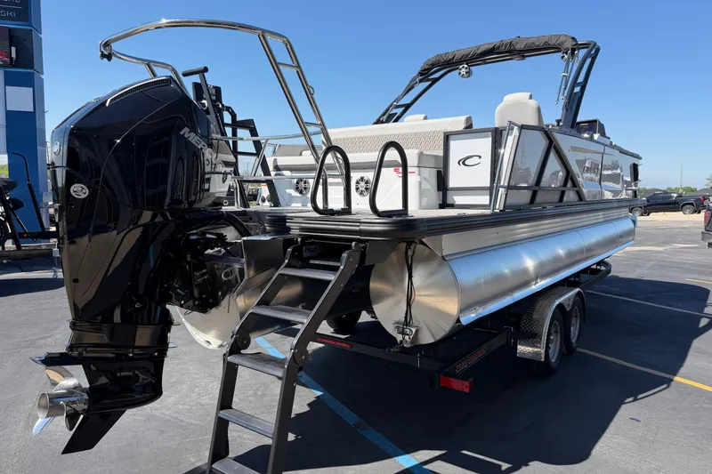 Slide: The Image of 2026 Crest Caribbean 250 SLS pontoon boat with powerful Mercury outboard engine on trailer. - 8