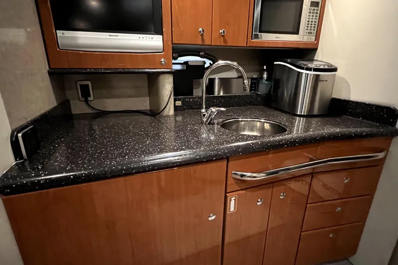 Slide: The Image of 2006 Formula 37 Performance Cruiser kitchen with sleek countertop, sink, and appliances. - 15