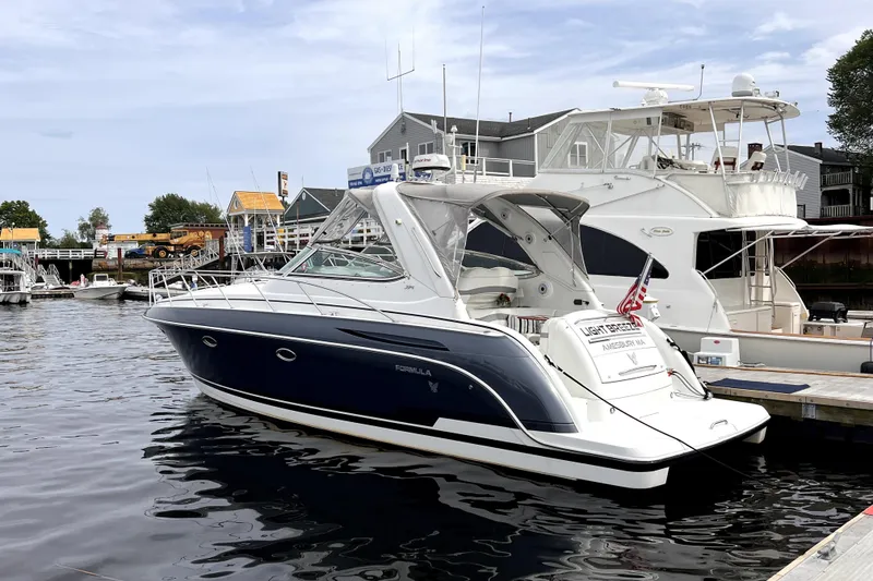 Slide: The Image of 2006 Formula 37 Performance Cruiser docked at marina, featuring sleek design and American flag. - 2