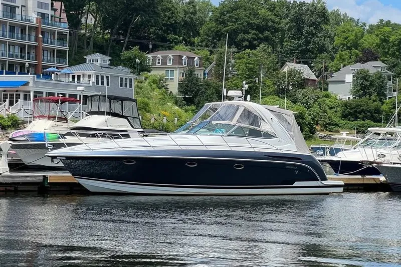 Slide: The Image of 2006 Formula 37 Performance Cruiser docked at a marina with scenic background. - 4