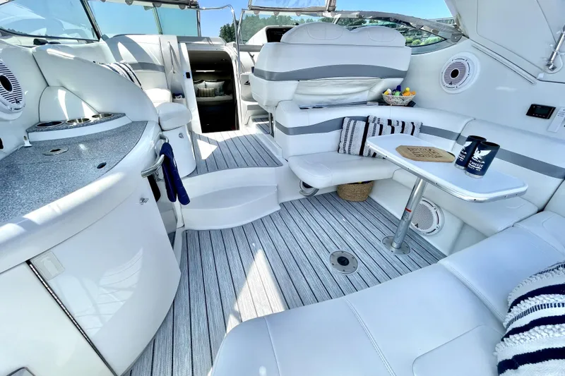 Slide: The Image of Luxurious interior of a 2006 Formula 37 Performance Cruiser with elegant seating and table setup. - 9