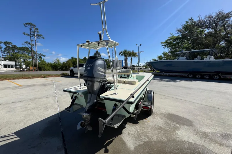 Slide: The Image of 2015 Hells Bay Professional boat with Yamaha motor on trailer, parked outdoors. - 11