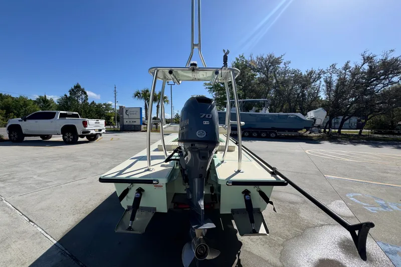 Slide: The Image of 2015 Hells Bay Professional boat with Yamaha engine in a sunny parking lot. - 12