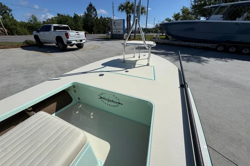 Slide: The Image of 2015 Hells Bay Professional boat on trailer, parked near a white GMC truck. - 16