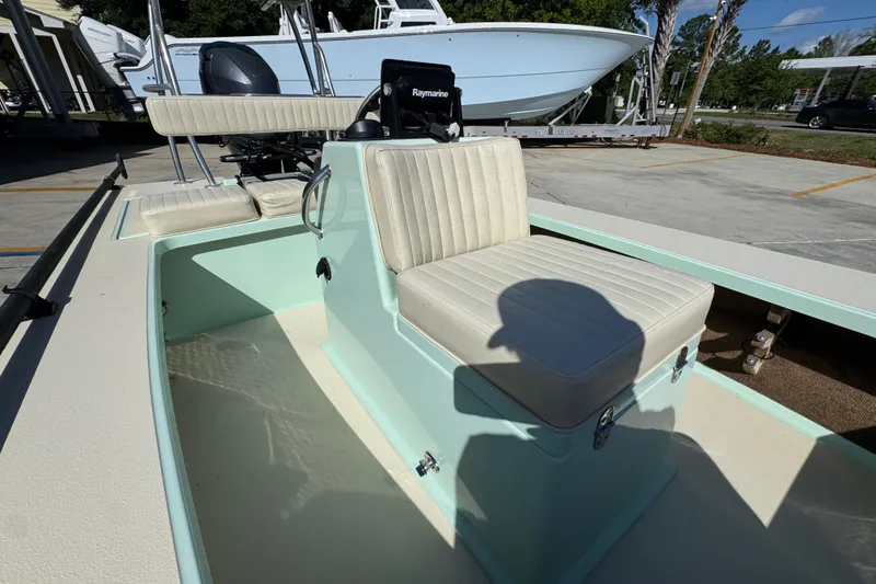 Slide: The Image of 2015 Hells Bay Professional boat interior with seating and Raymarine equipment. - 22