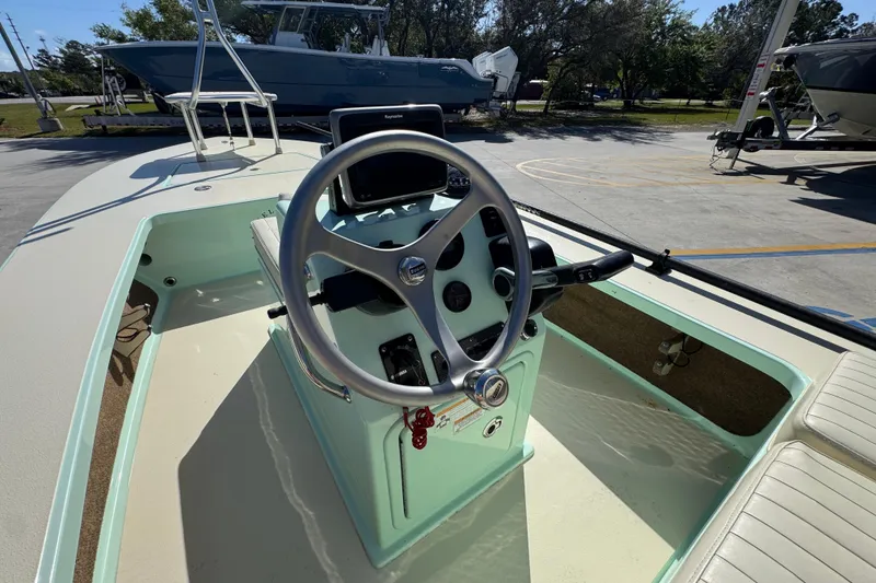 Slide: The Image of 2015 Hells Bay Professional boat cockpit with steering wheel and control panel. - 23