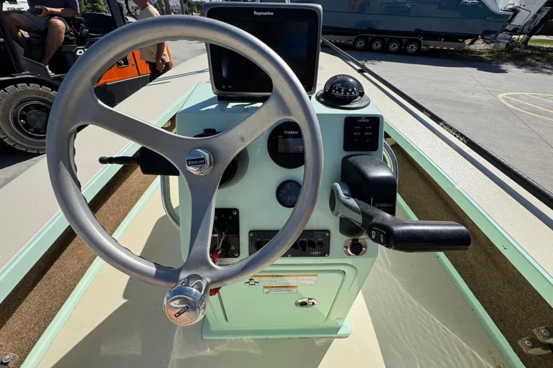 Slide: The Image of Helm of 2015 Hells Bay Professional boat with steering wheel and control panel. - 24