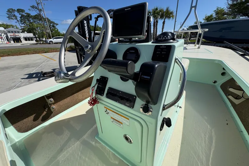 Slide: The Image of 2015 Hells Bay Professional boat console with steering wheel and navigation equipment. - 25