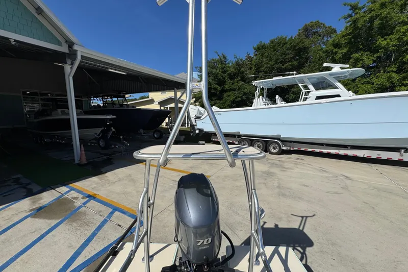 Slide: The Image of 2015 Hells Bay Professional boat with outboard motor in a marina setting. - 27