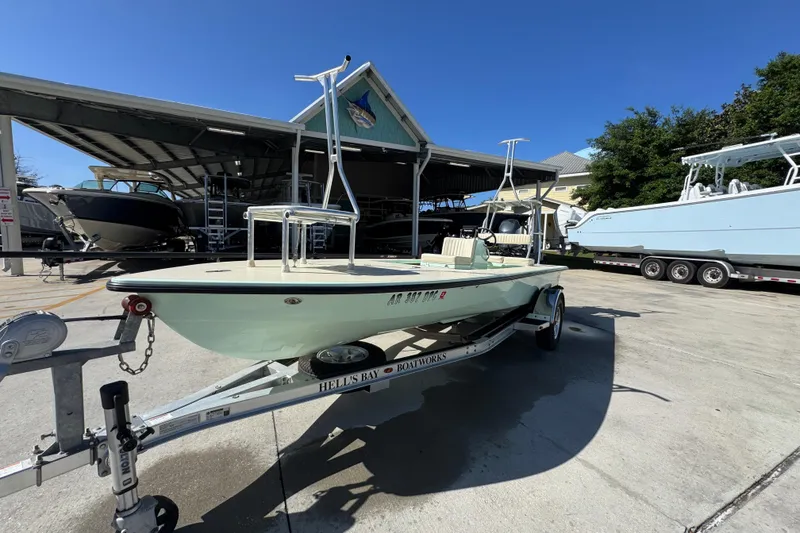 Slide: The Image of 2015 Hells Bay Professional boat on trailer at a marina under clear blue sky. - 3