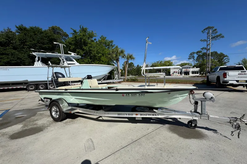 Slide: The Image of 2015 Hells Bay Professional boat on trailer, parked outdoors under clear blue sky. - 7