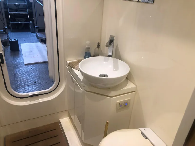 Slide: The Image of 2012 Monte Carlo Yachts 76 bathroom with modern sink and door to deck. - 17