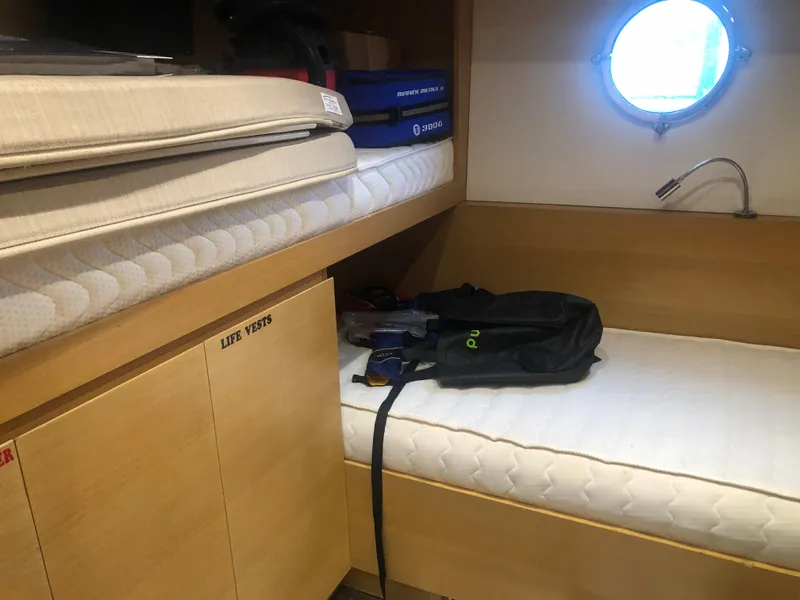 Slide: The Image of 2012 Monte Carlo Yachts 76 cabin with bunk beds and porthole window. - 19