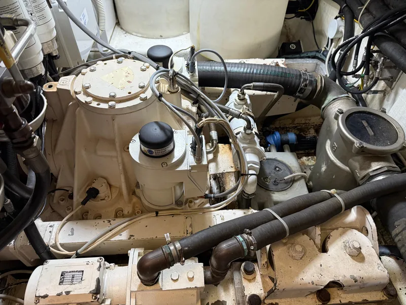 Slide: The Image of Engine room of a 2012 Monte Carlo Yachts 76, showcasing mechanical components and piping. - 48