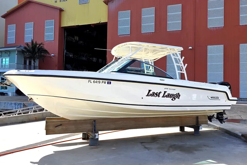The Image of 2015 Boston Whaler 270 Vantage boat named "Last Laugh" on a dock. - 0