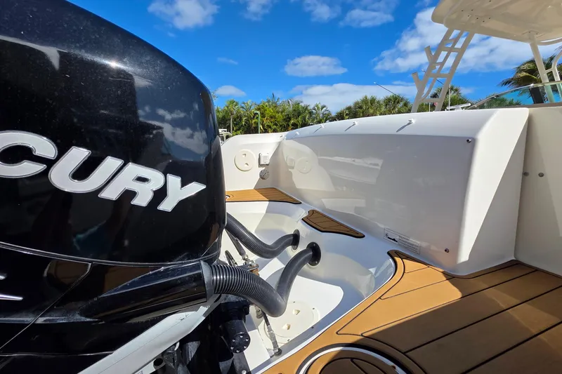 Slide: The Image of 2015 Boston Whaler 270 Vantage boat with Mercury engine, under clear blue sky. - 16