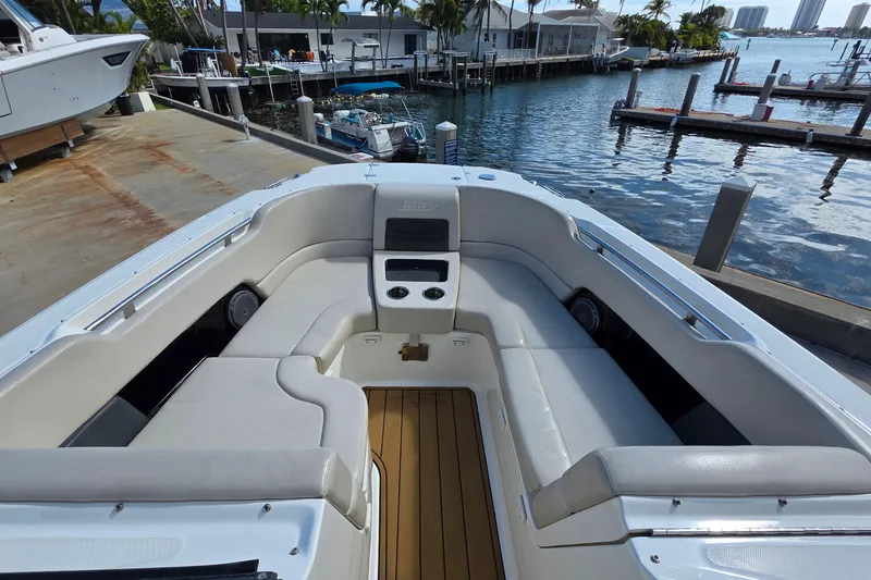 Slide: The Image of 2015 Boston Whaler 270 Vantage boat interior with seating and waterfront view. - 17