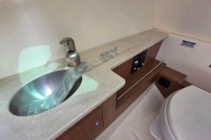 Slide: The Image of 2015 Boston Whaler 270 Vantage boat interior with sink and toilet. - 19