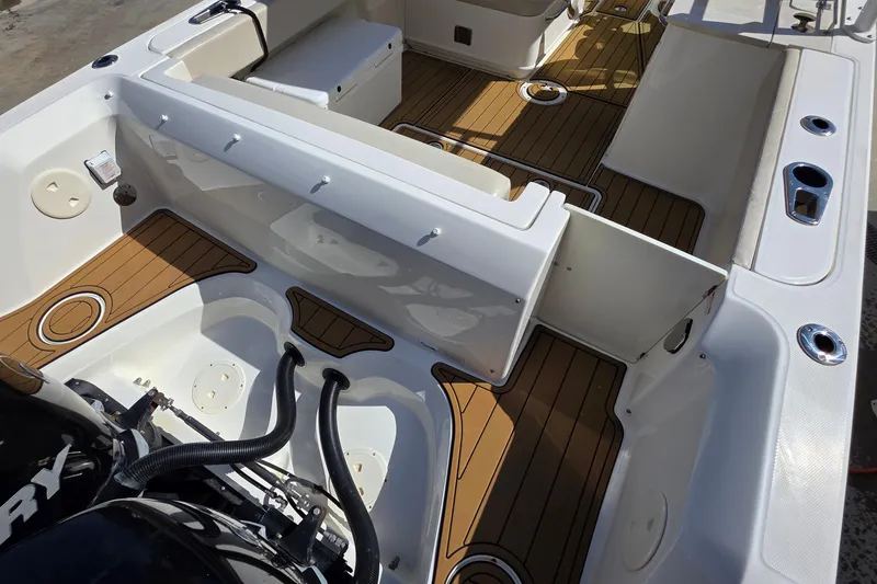 Slide: The Image of 2015 Boston Whaler 270 Vantage boat interior with teak flooring and seating arrangement. - 21