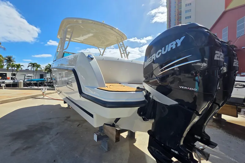 Slide: The Image of 2015 Boston Whaler 270 Vantage boat with Mercury Verado engines, docked under clear skies. - 25