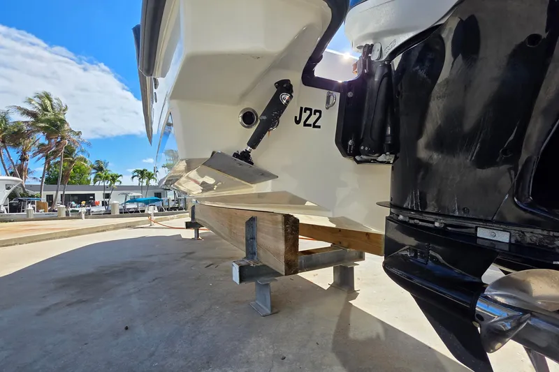 Slide: The Image of 2015 Boston Whaler 270 Vantage boat on dry dock, sunny day, palm trees in background. - 26
