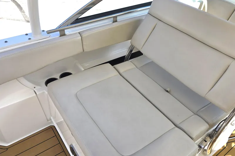 Slide: The Image of 2015 Boston Whaler 270 Vantage interior seating with beige upholstery and cup holders. - 31