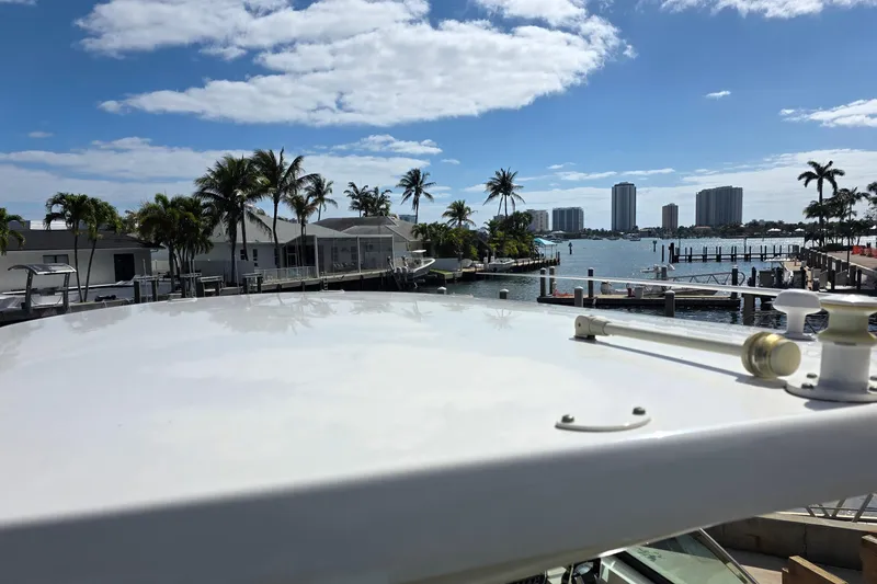 Slide: The Image of 2015 Boston Whaler 270 Vantage docked, overlooking a scenic waterfront with palm trees. - 32