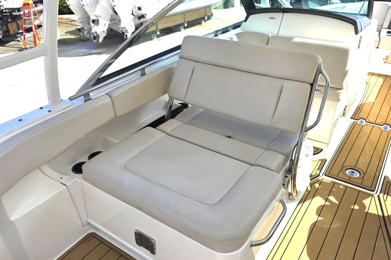 Slide: The Image of 2015 Boston Whaler 270 Vantage boat interior with beige seating and teak flooring. - 34