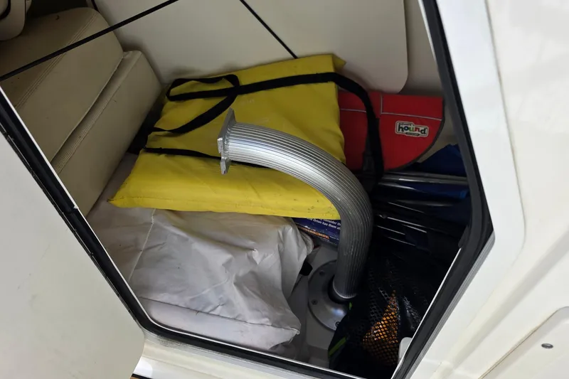 Slide: The Image of Storage compartment of a 2015 Boston Whaler 270 Vantage with boating gear and accessories. - 35