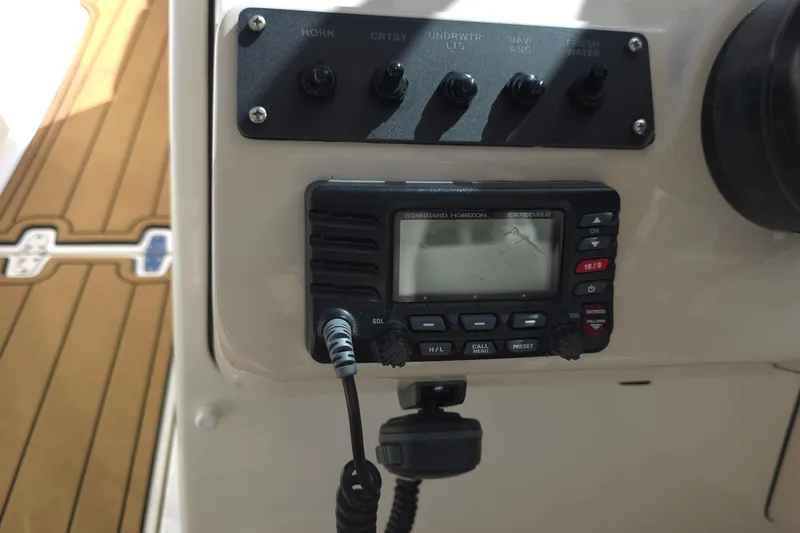 Slide: The Image of Control panel and radio on a 2015 Boston Whaler 270 Vantage boat. - 36
