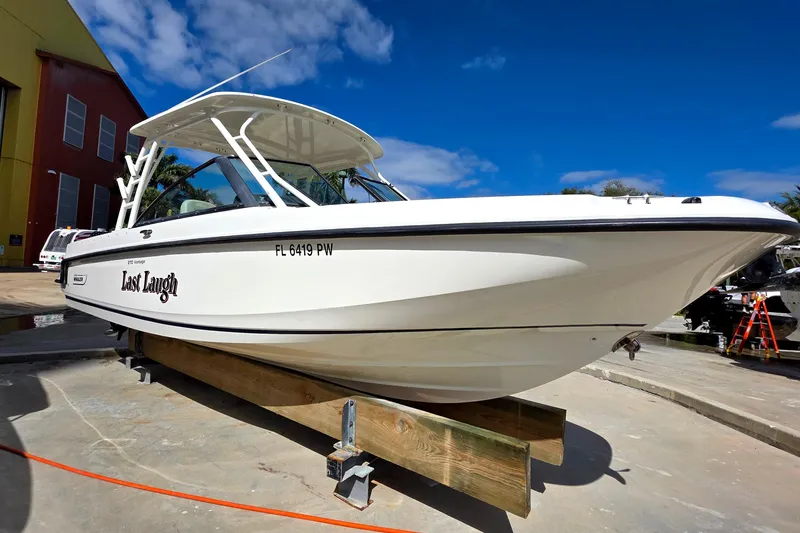 Slide: The Image of 2015 Boston Whaler 270 Vantage boat named "Last Laugh" on display outdoors. - 4