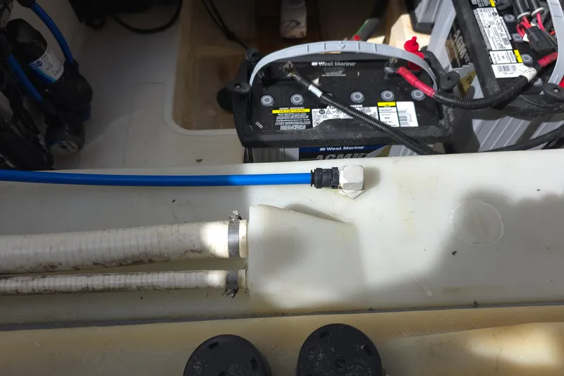 Slide: The Image of Battery compartment of a 2015 Boston Whaler 270 Vantage with wiring and hoses visible. - 41